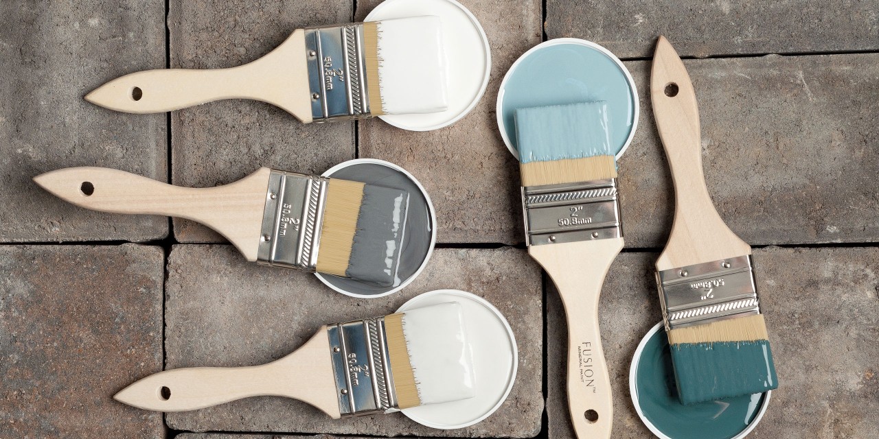 Fusion Paint lids and paint brushes flat lay blue, grey and white