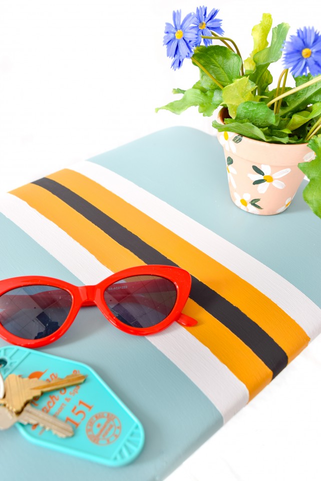 red sunglasses on a vintage striped stool