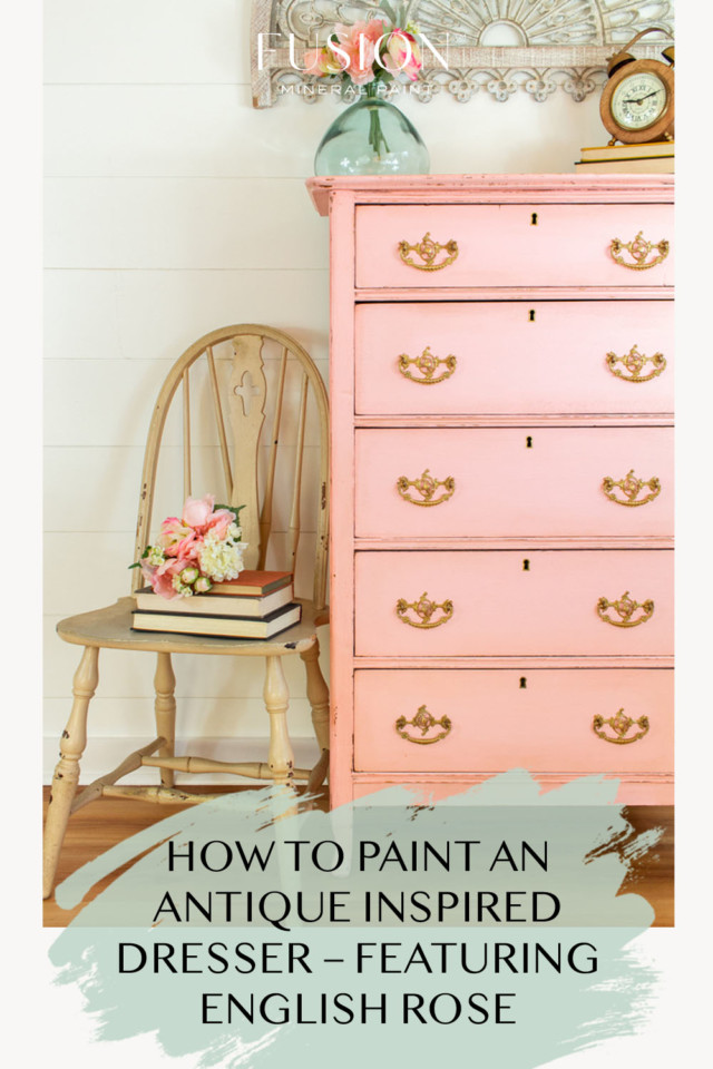 tall pink painted dresser with beige chair beside it
