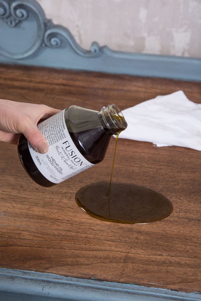 Hemp Oil being poured on a wooden surface.