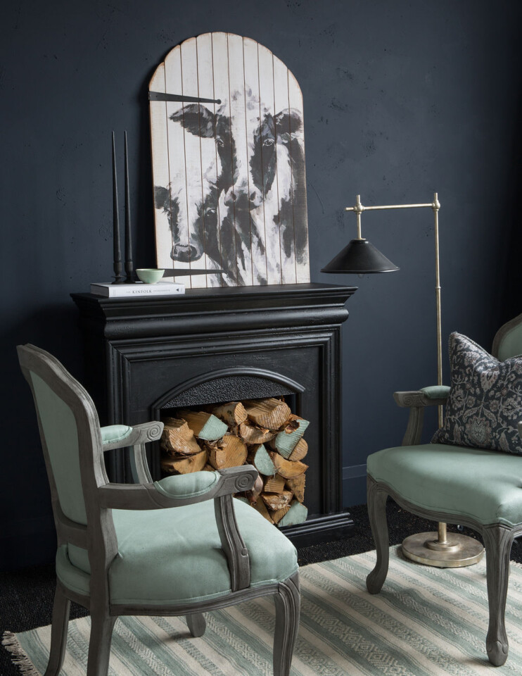 Dark Midnight blue wall fire place and 2 chairs 