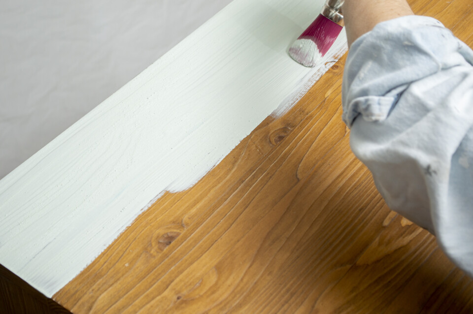 Painting a table top with red brush green paint