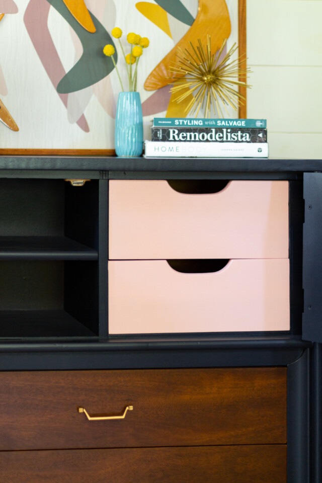 Dresser cabinet open revealing pink drawers
