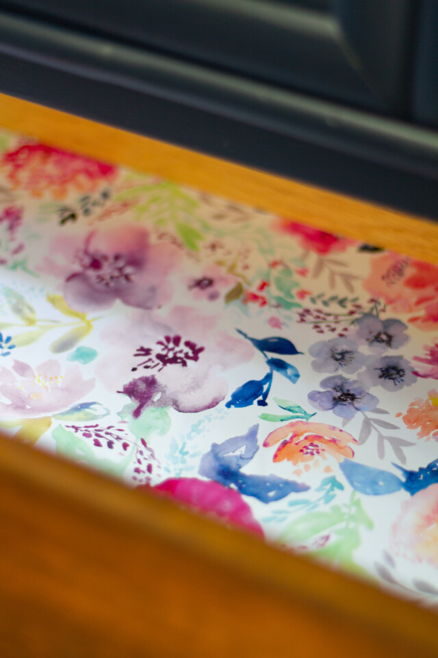Close up of inside drawers with bright floral wallpaper