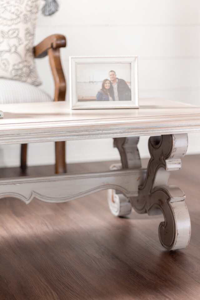 Coffee table painted and staged with a couples photo in a white frame sitting on top
