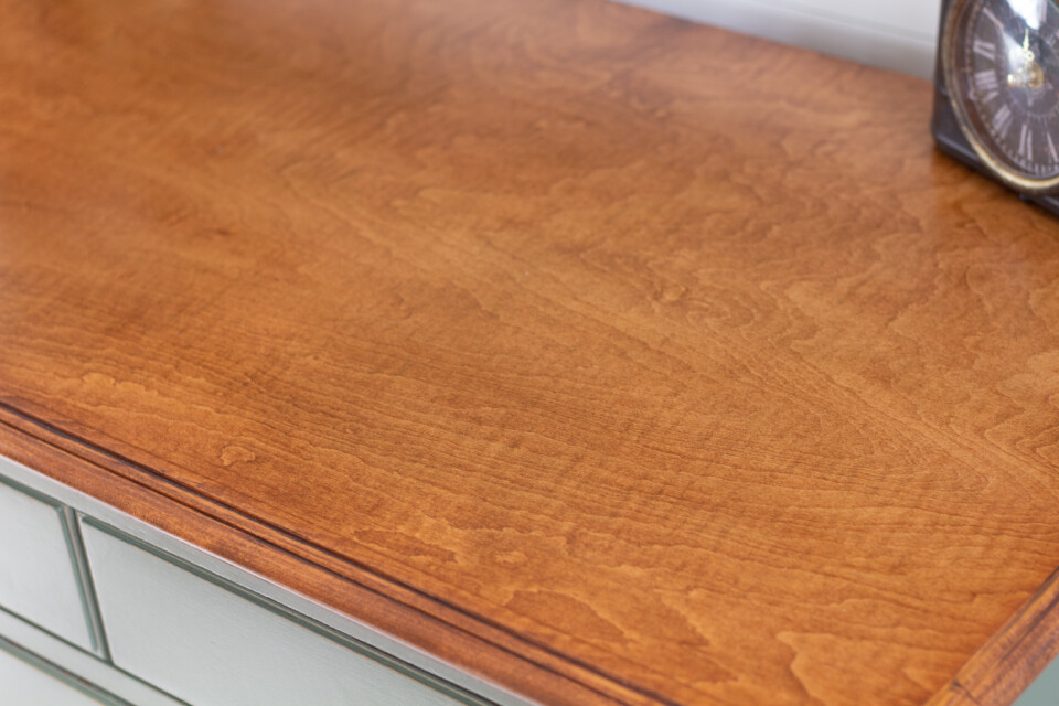 Close up of natural wood grain top of dresser