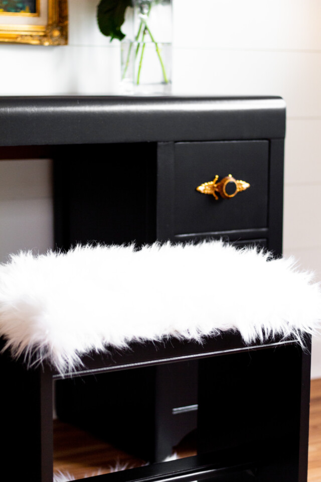 Close up image of faux fur bench and deco desk drawer