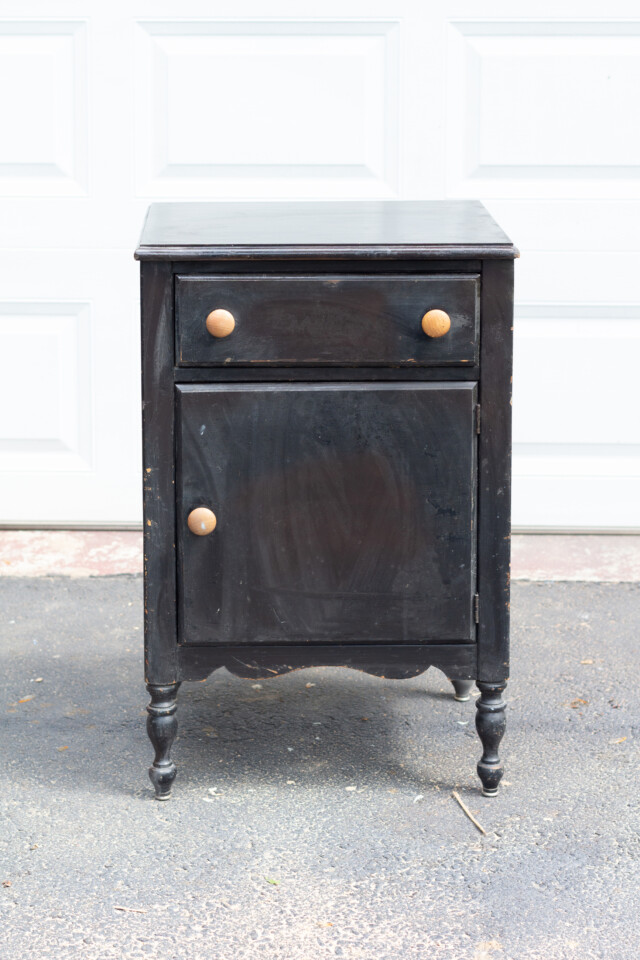 Old and worn black bedside table