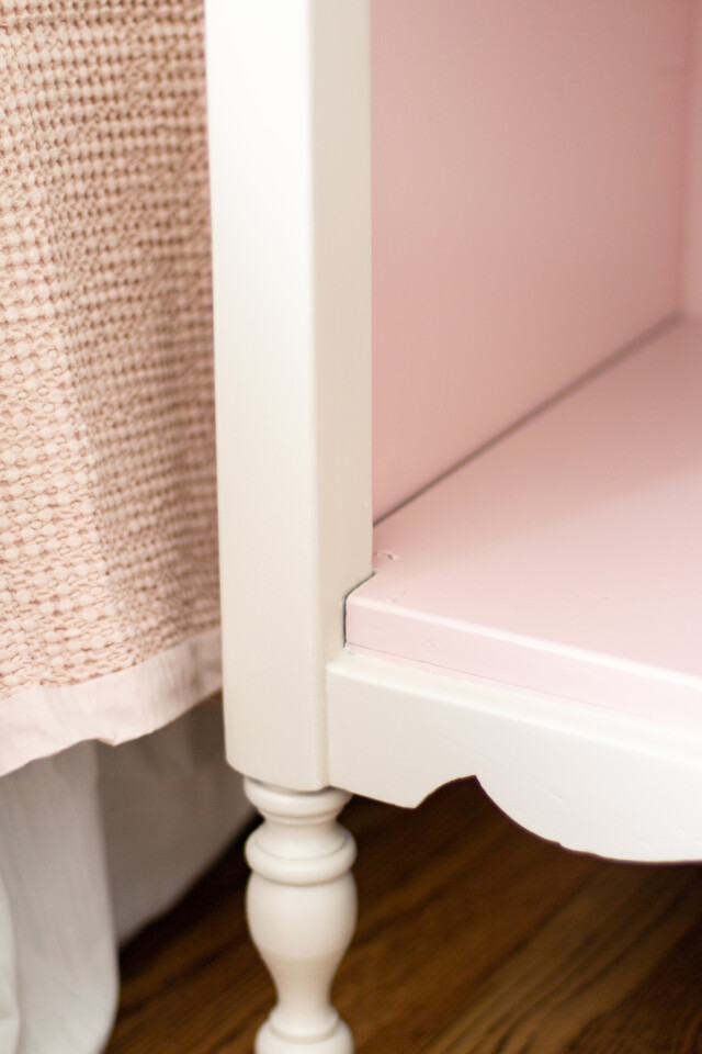 Open cupboard on bedside tables, pink inside