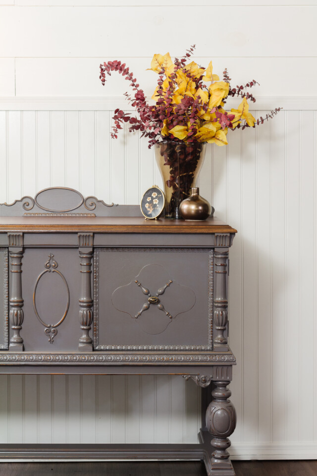 Up close image of Jacobean Buffet Upcycled with Hazelwood, staged with fall themed bouquet on top