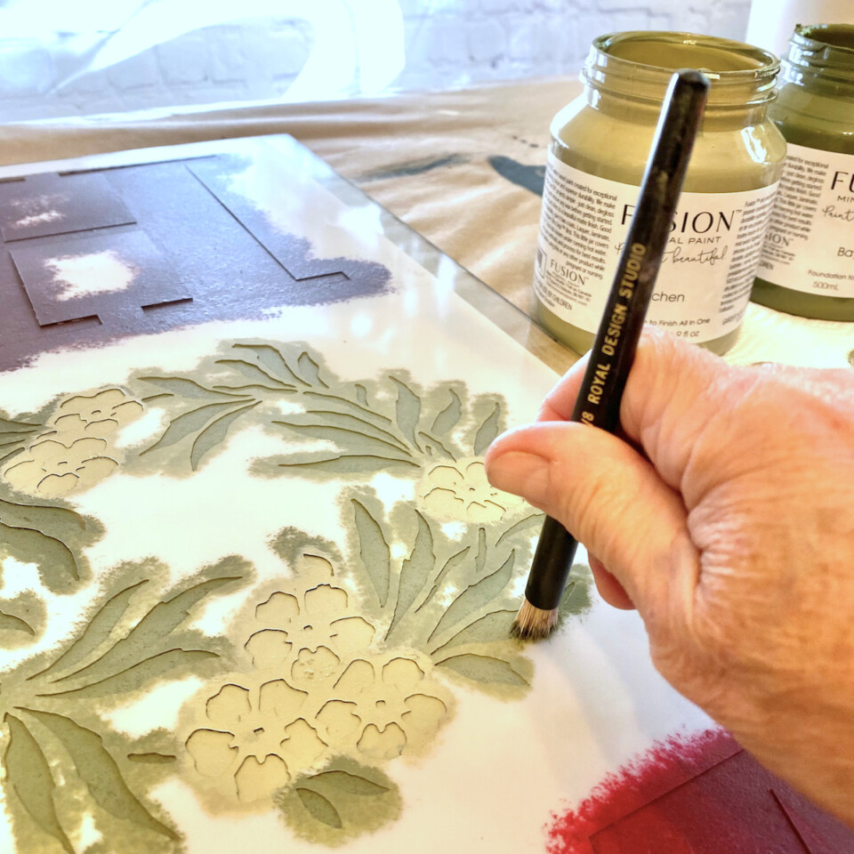 Close up view of paint stencilling a leaf design
