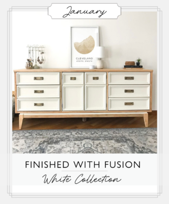 White dresser with natural wood accents, staged with