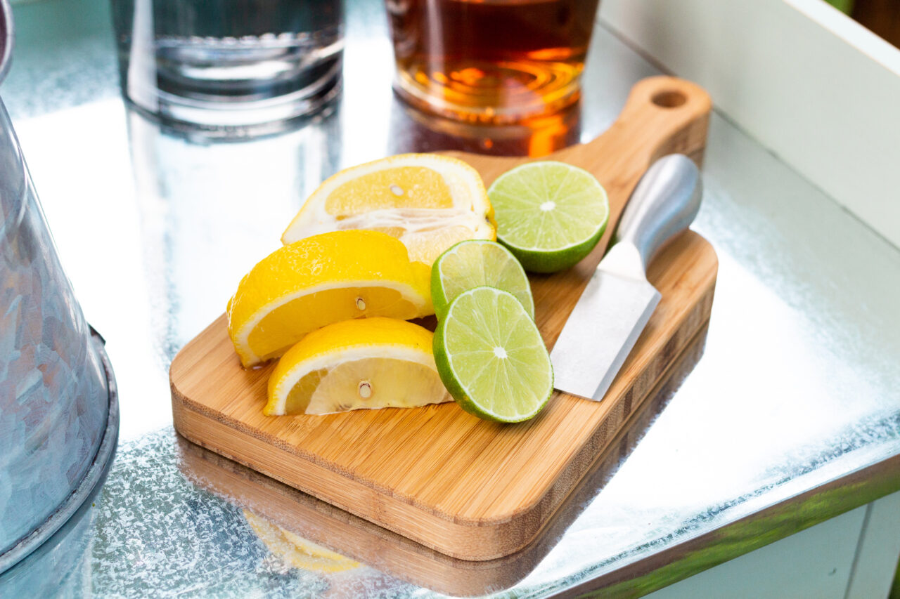 up close image of cutting board with sliced lemons and limes