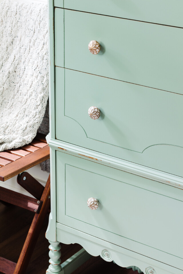 up close of the drawers of the painted dresser staged with beachy, coastal decor