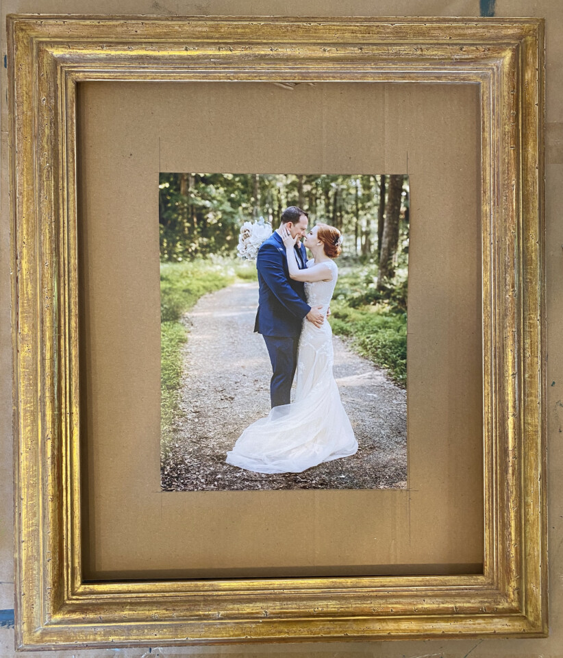 Gold picture frame with a wedding photo inside