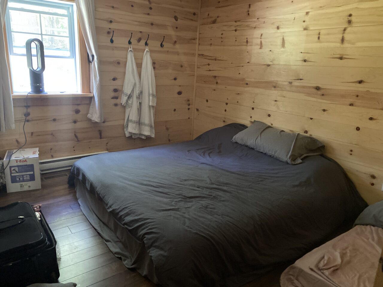 cottage makeover series / plain bedroom with wood walls and grey bedding
