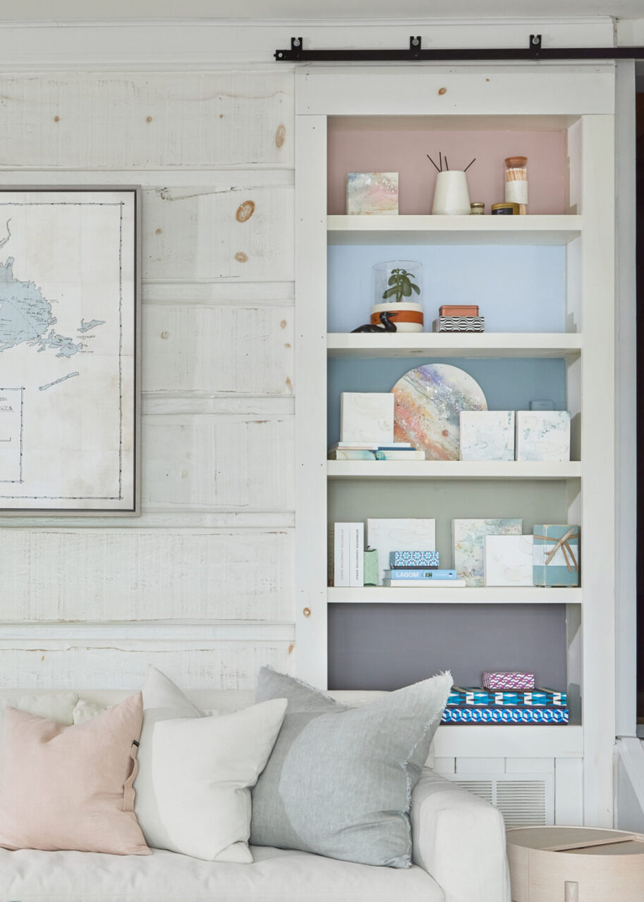 Living room / Pastel painted shelves (pink, varying blues, green and purple/grey) with a variety of home decor