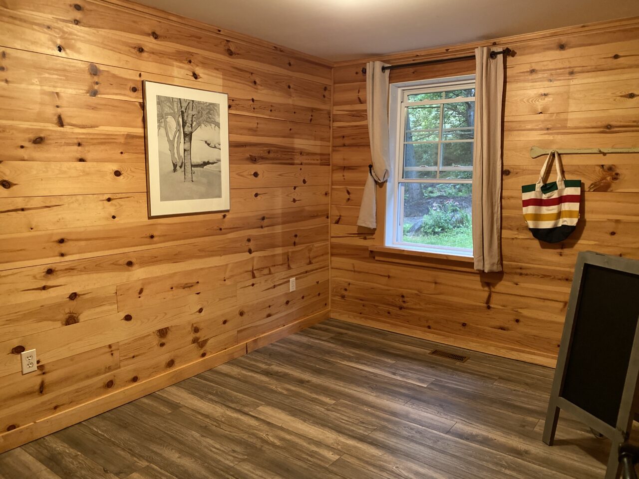 Pine walled room with dark grey flooring