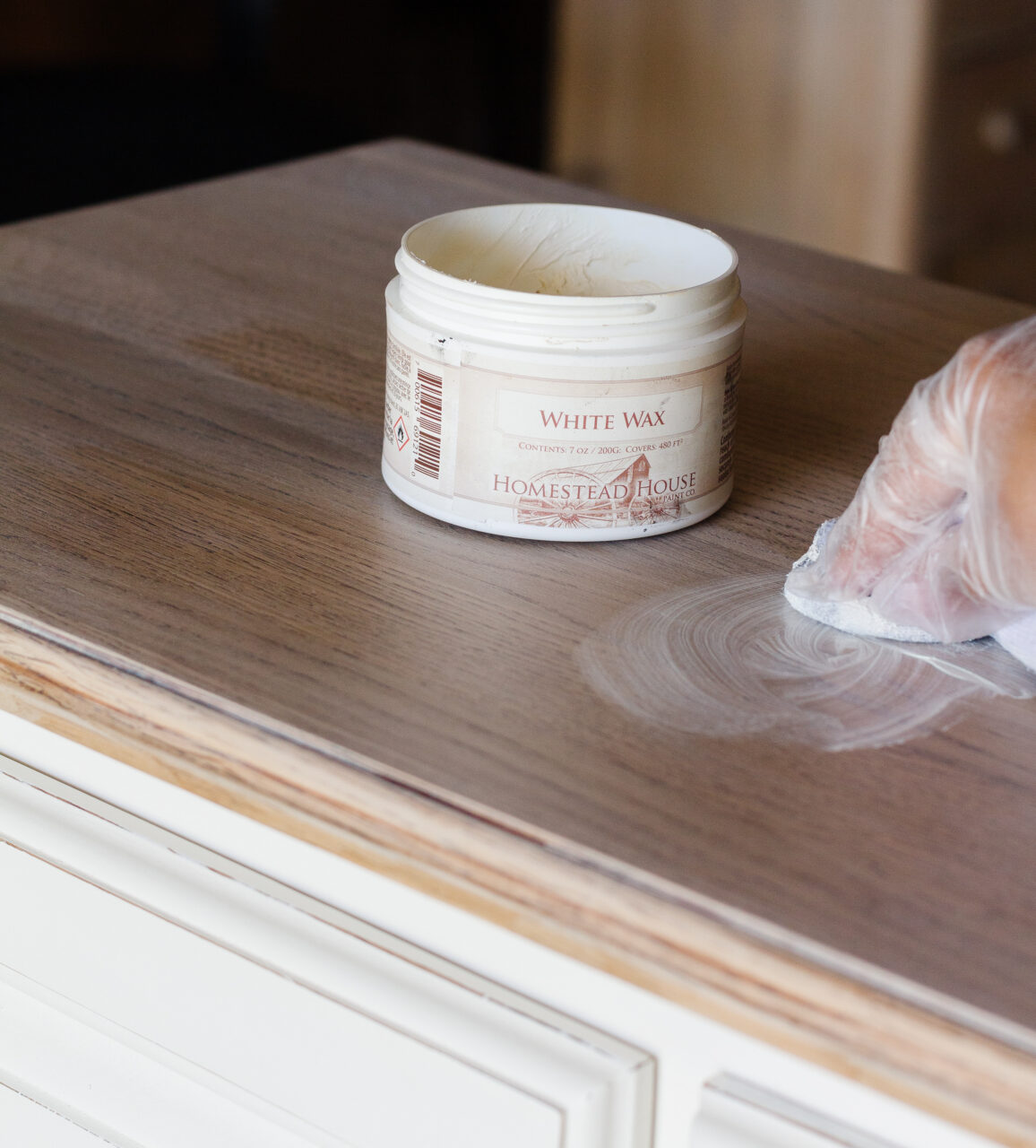 white wax container sitting on top of dresser